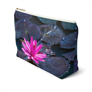Goddess Swag Bag Mini called Lotus Love.  Bag can be used as an accessory bag, makeup or cosmetic bag.  One side of bag shows a pink lotus with lily pad background and goddess swag writing in gold above the lotus.  The other side of the bag shows the pink lotus and lily pad background only.