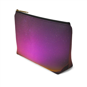 Goddess Swag Bag Mini (named cosmic).  Item can be used as accessory pouch, makeup bag or cosmetic bag with a background is purple with some orange like sunset.  Goddess Swag wording is in gold on one side of the bag only.  There is an option of a black or a white zipper, and a large or a small bag. 