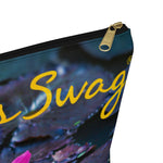 Load image into Gallery viewer, Goddess Swag Bag Mini called Lotus Love.  Bag can be used as an accessory bag, makeup or cosmetic bag.  One side of bag shows a pink lotus with lily pad background and goddess swag writing in gold above the lotus.  The other side of the bag shows the pink lotus and lily pad background only.
