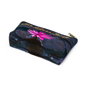 Goddess Swag Bag Mini called Lotus Love.  Bag can be used as an accessory bag, makeup or cosmetic bag.  One side of bag shows a pink lotus with lily pad background and goddess swag writing in gold above the lotus.  The other side of the bag shows the pink lotus and lily pad background only.