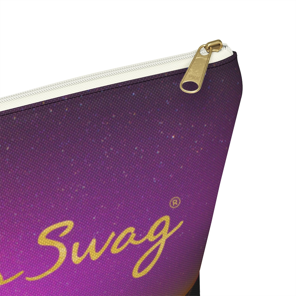 Goddess Swag Bag Mini (named cosmic).  Item can be used as accessory pouch, makeup bag or cosmetic bag with a background is purple with some orange like sunset.  Goddess Swag wording is in gold on one side of the bag only.  There is an option of a black or a white zipper, and a large or a small bag. 