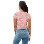 Load image into Gallery viewer, Light to medium pink background with pastel and gold color sri yantra design all over front back and short sleeves.  This is a crop top tee by goddess swag as part of the cosmic powers collection
