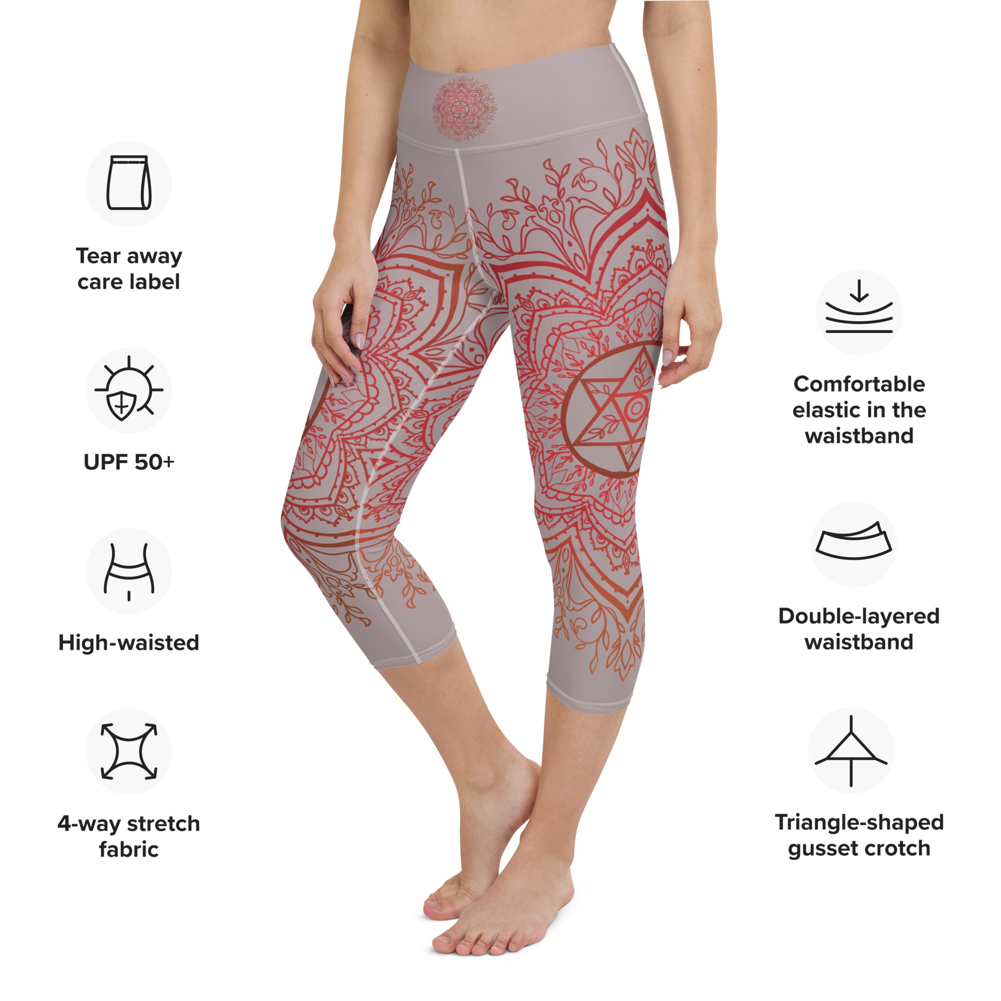 Yoga capri leggings midcalf length by Goddess Swag.  Background solid color is a medium grey. design overlay in front and back is a red mandala print for the earth star chakra.  On front waist is the earth star chakra centered. On back waist is goddess swag written out in red.