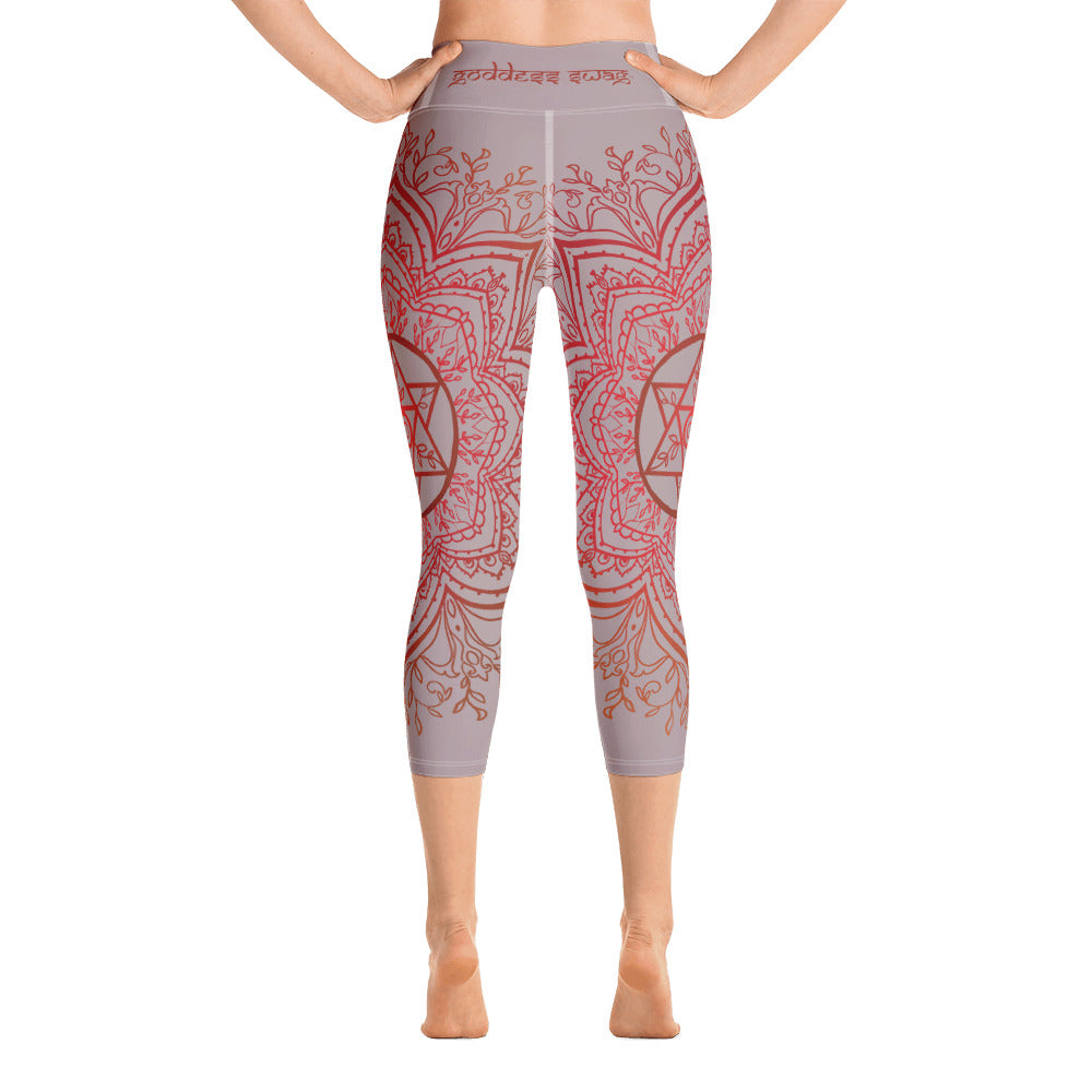Yoga capri leggings midcalf length by Goddess Swag.  Background solid color is a medium grey. design overlay in front and back is a red mandala print for the earth star chakra.  On front waist is the earth star chakra centered. On back waist is goddess swag written out in red.