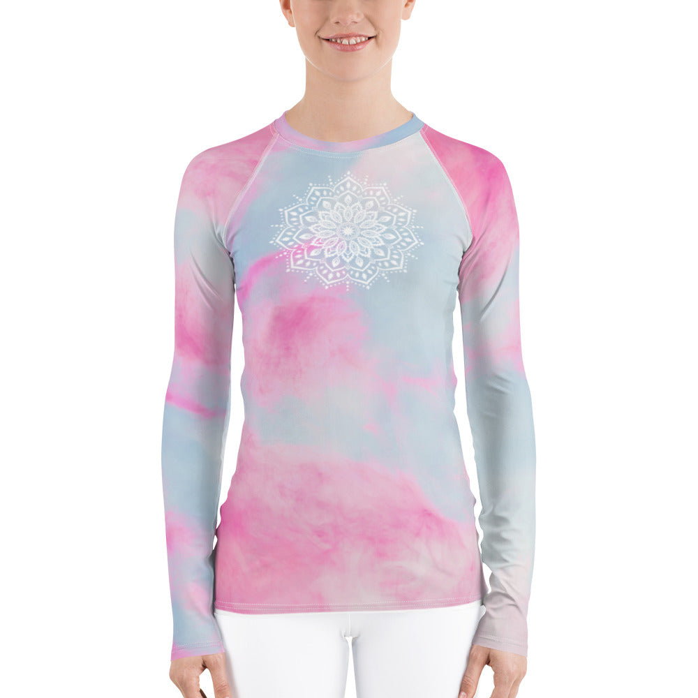 long sleeve rash guard  UPF 50 sun protection.  Design is white mandala on the front chest and white heart chakra mandala on the back. The background is a soft pastel of pink and blue by goddess swag.