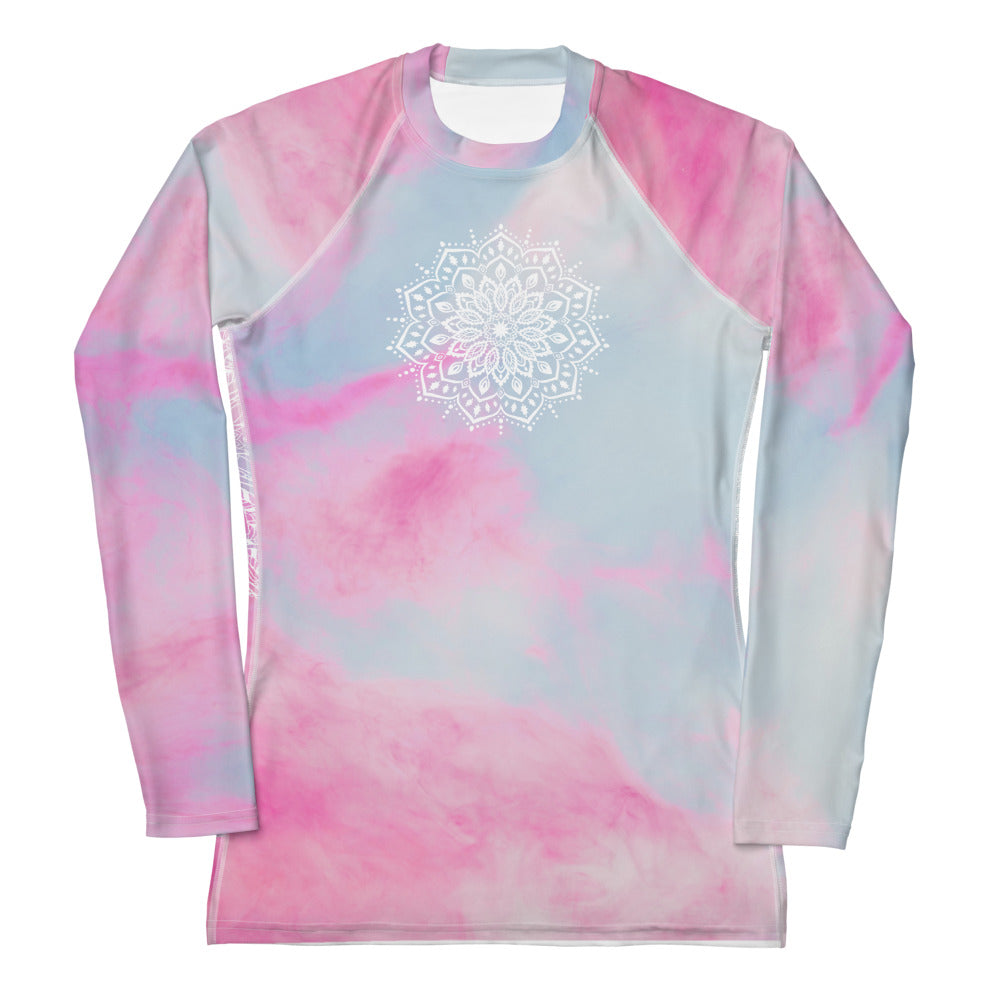 long sleeve rash guard  UPF 50 sun protection.  Design is white mandala on the front chest and white heart chakra mandala on the back. The background is a soft pastel of pink and blue by goddess swag.