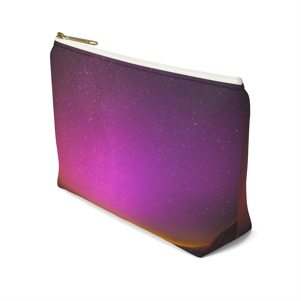 Goddess Swag Bag Mini (named cosmic).  Item can be used as accessory pouch, makeup bag or cosmetic bag with a background is purple with some orange like sunset.  Goddess Swag wording is in gold on one side of the bag only.  There is an option of a black or a white zipper, and a large or a small bag. 