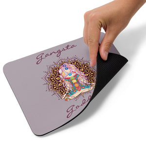Mouse pad with Gangsta Goddess written in a deep purple and a design image of a goddess sitting in lotus yoga position with a mandala behind her and all 7 chakra colors from root to crown.  The background is a mauve gray solid color.  Size: 8.7″ × 7.1″ × 0.12″ 