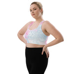 Load image into Gallery viewer, longline sports bra by goddess swag. main colors are pastel pinks and blues. the design overlay on front and back is a white heart chakra mandala design. goddess swag is written on the back in sanskrit style writing
