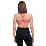 Load image into Gallery viewer, longline sports bra by goddess swag. the design has a pink orange background with an overlay of a root chakra mandala design in red and orange. this design is on front and back of sports bra.
