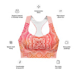 Load image into Gallery viewer, longline sports bra by goddess swag. the design has a pink orange background with an overlay of a root chakra mandala design in red and orange. this design is on front and back of sports bra.
