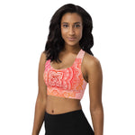 Load image into Gallery viewer, longline sports bra by goddess swag. the design has a pink orange background with an overlay of a root chakra mandala design in red and orange. this design is on front and back of sports bra.
