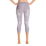 Load image into Gallery viewer, mystic-77-heart-chakra-mandala-capri-leggings-by-goddess-swag.  Background color is a light to medium mauve.  The mandala design is white and all over front and back. Goddess Swag is written on the back waistband in sanskrit style in a deep purple.
