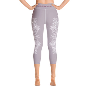 mystic-77-heart-chakra-mandala-capri-leggings-by-goddess-swag.  Background color is a light to medium mauve.  The mandala design is white and all over front and back. Goddess Swag is written on the back waistband in sanskrit style in a deep purple.