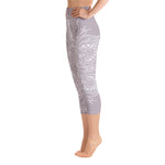 Load image into Gallery viewer, mystic-77-heart-chakra-mandala-capri-leggings-by-goddess-swag.  Background color is a light to medium mauve.  The mandala design is white and all over front and back. Goddess Swag is written on the back waistband in sanskrit style in a deep purple.
