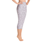 Load image into Gallery viewer, mystic-77-heart-chakra-mandala-capri-leggings-by-goddess-swag.  Background color is a light to medium mauve.  The mandala design is white and all over front and back. Goddess Swag is written on the back waistband in sanskrit style in a deep purple.

