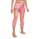 Load image into Gallery viewer, capri mid calf leggings. design is root chakra mandala of orange and red on legs front and back.  the front waistband has the root chakra symbol in the center while the back has goddess swag written on the waist band.
