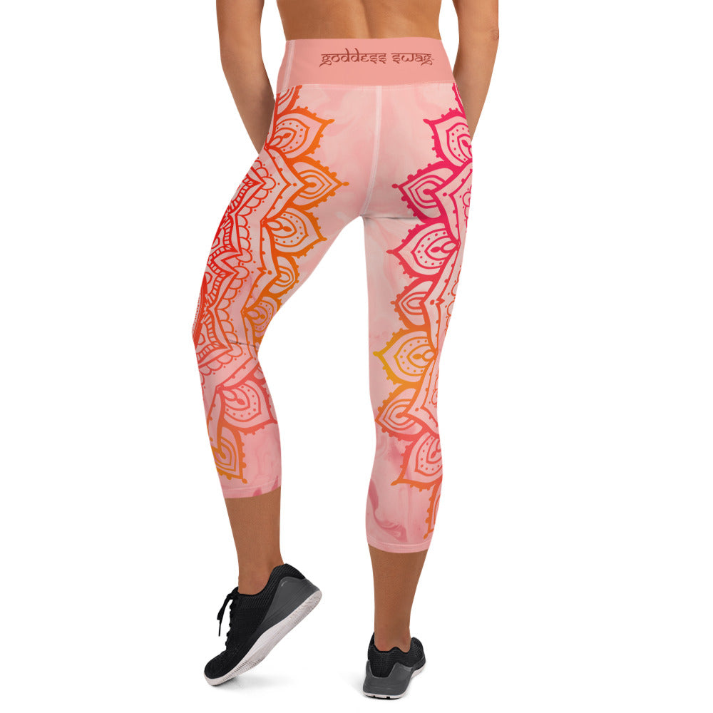 capri mid calf leggings. design is root chakra mandala of orange and red on legs front and back.  the front waistband has the root chakra symbol in the center while the back has goddess swag written on the waist band.