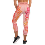 Load image into Gallery viewer, capri mid calf leggings. design is root chakra mandala of orange and red on legs front and back.  the front waistband has the root chakra symbol in the center while the back has goddess swag written on the waist band.
