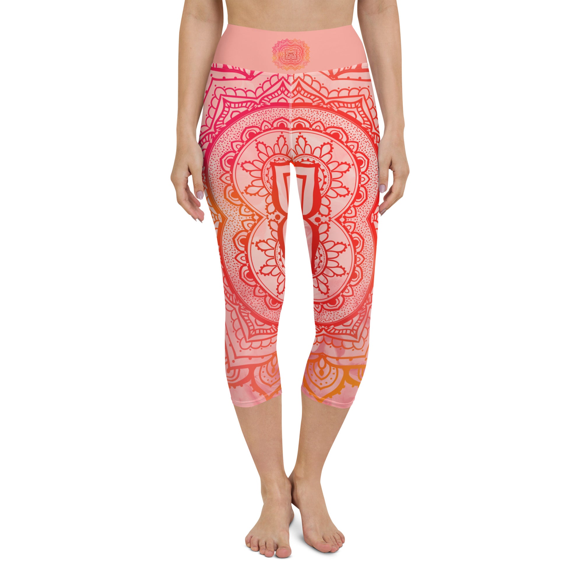 capri mid calf leggings. design is root chakra mandala of orange and red on legs front and back.  the front waistband has the root chakra symbol in the center while the back has goddess swag written on the waist band.