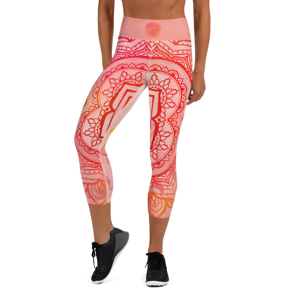 capri mid calf leggings. design is root chakra mandala of orange and red on legs front and back.  the front waistband has the root chakra symbol in the center while the back has goddess swag written on the waist band.