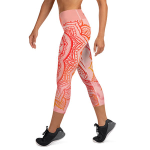 capri mid calf leggings. design is root chakra mandala of orange and red on legs front and back.  the front waistband has the root chakra symbol in the center while the back has goddess swag written on the waist band.