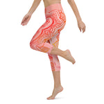 Load image into Gallery viewer, capri mid calf leggings. design is root chakra mandala of orange and red on legs front and back.  the front waistband has the root chakra symbol in the center while the back has goddess swag written on the waist band.
