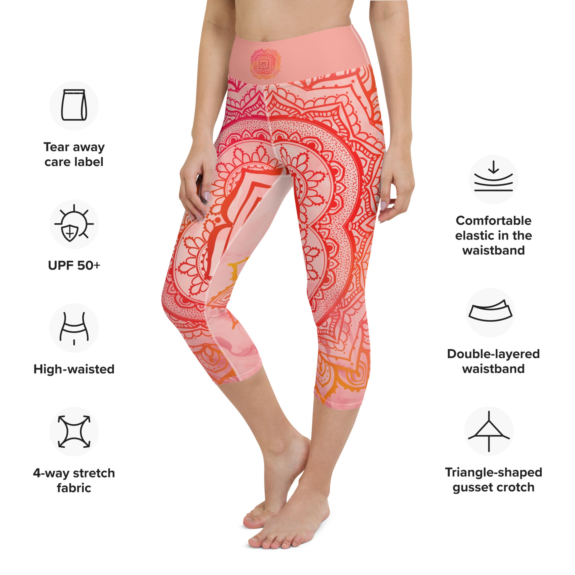 capri mid calf leggings. design is root chakra mandala of orange and red on legs front and back.  the front waistband has the root chakra symbol in the center while the back has goddess swag written on the waist band.