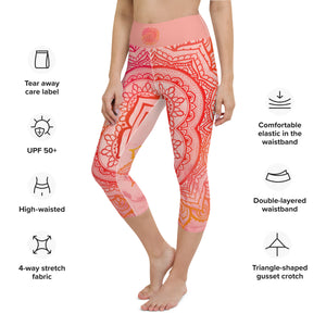 capri mid calf leggings. design is root chakra mandala of orange and red on legs front and back.  the front waistband has the root chakra symbol in the center while the back has goddess swag written on the waist band.