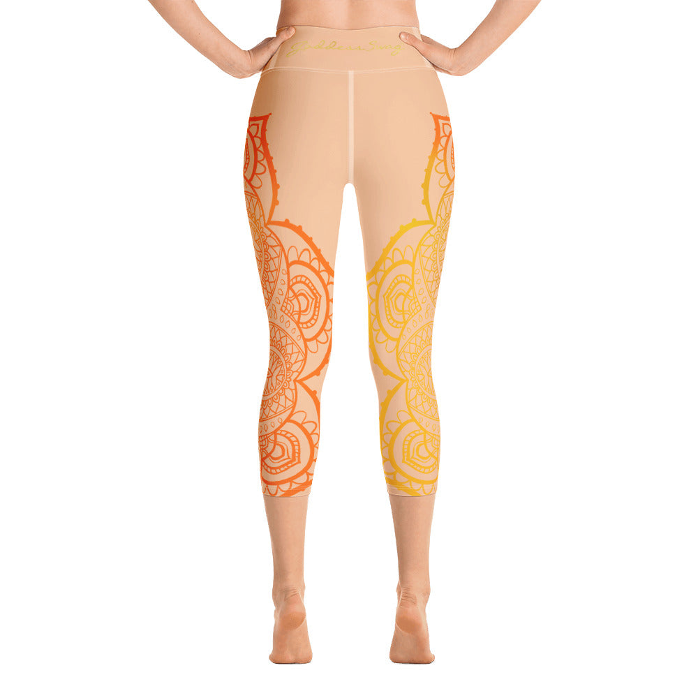 yoga capri leggings by goddess swag. Design is a sacral chakra mandala on front and back of leggings in deep orange and light yellow coloring.  Back waist has goddess swag written in light gold. mid calf legging length.