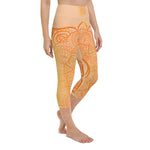 Load image into Gallery viewer, yoga capri leggings by goddess swag. Design is a sacral chakra mandala on front and back of leggings in deep orange and light yellow coloring.  Back waist has goddess swag written in light gold. mid calf legging length.
