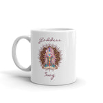 Load image into Gallery viewer, Goddess Swag, ceramic coffee mug 11 ounces. Goddess with Mandala behind her and seven colorful chakras from root to crown. She is sitting in lotus position. Goddess Swag which is written in deep purple color.
