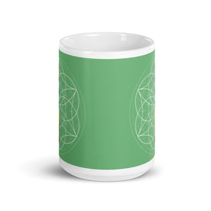 Jade heart chakra ceramic coffee mug design is a green background with sacred geometry and all seven chakras.  coffee mug is 15 ounces. By goddess swag