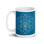 Load image into Gallery viewer, Apatite throat chakra ceramic coffee mug design is a blue background with sacred geometry and all seven chakras.  coffee mug is 15 ounces. By goddess swag

