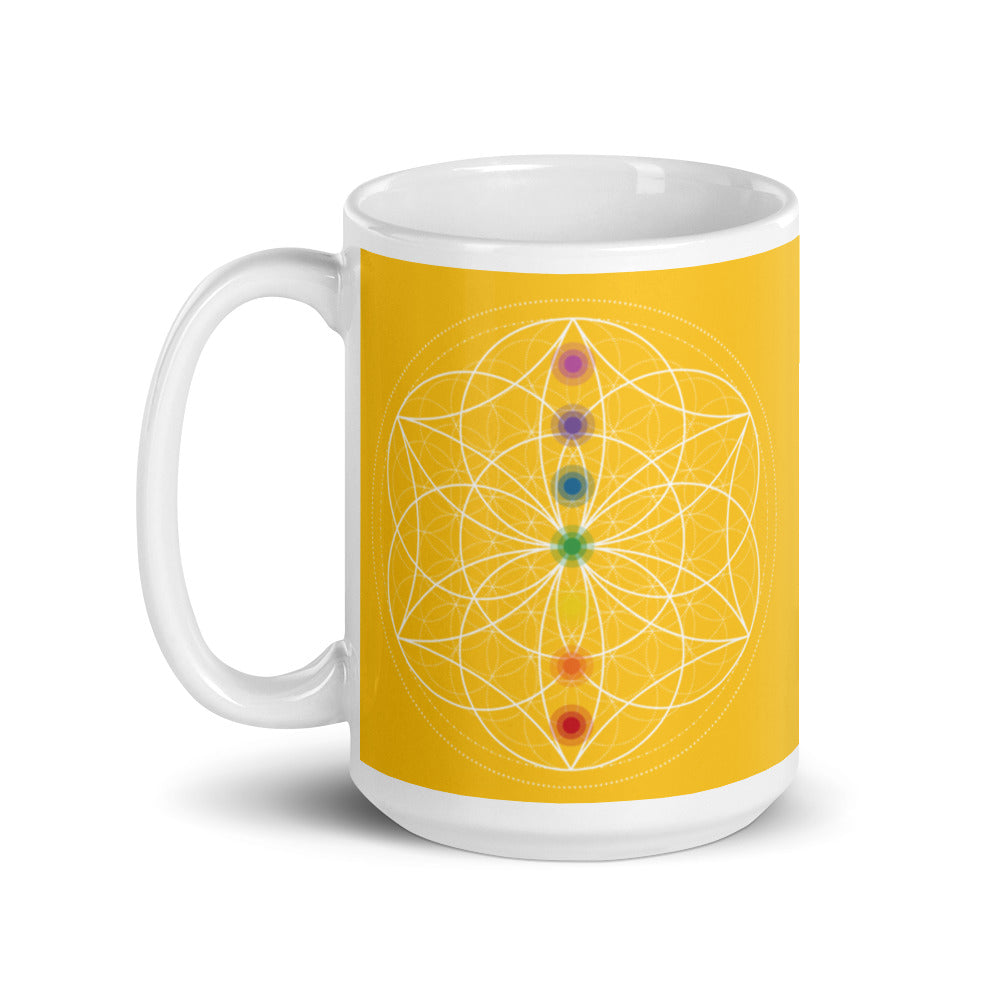 citrine solar plexus chakra ceramic coffee mug design is a yellow background with sacred geometry and all seven chakras.  coffee mug is 15 ounces. By goddess swag