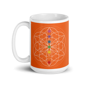 carnelian Sacral chakra ceramic coffee mug design is an orange background with sacred geometry and all seven chakras.  coffee mug is 15 ounces. By goddess swag