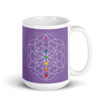 Load image into Gallery viewer, Amethyst third eye chakra ceramic coffee mug design is a light purple background with sacred geometry and all seven chakras.  coffee mug is 15 ounces. By goddess swag
