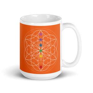 carnelian Sacral chakra ceramic coffee mug design is an orange background with sacred geometry and all seven chakras.  coffee mug is 15 ounces. By goddess swag